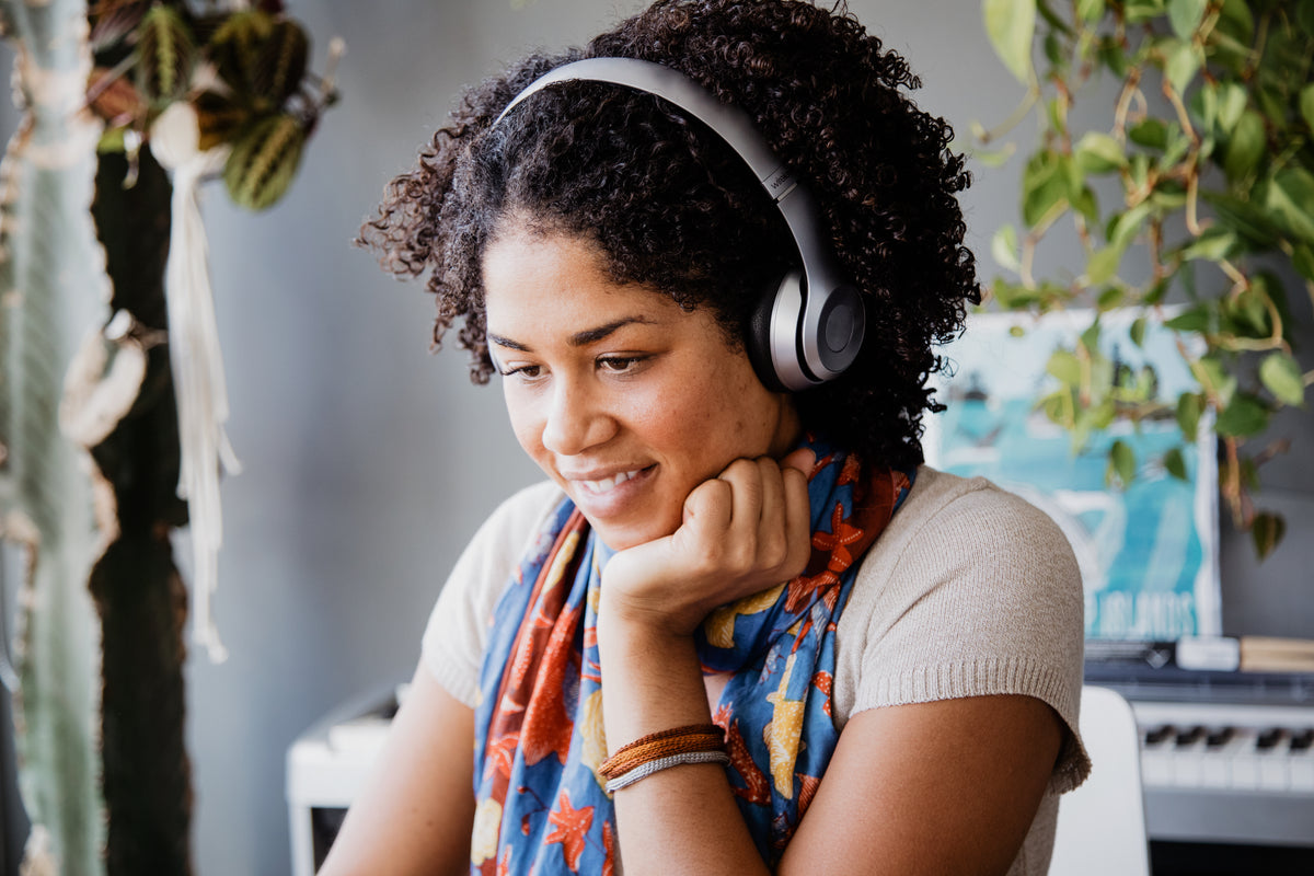 A woman listening to music with headphones
