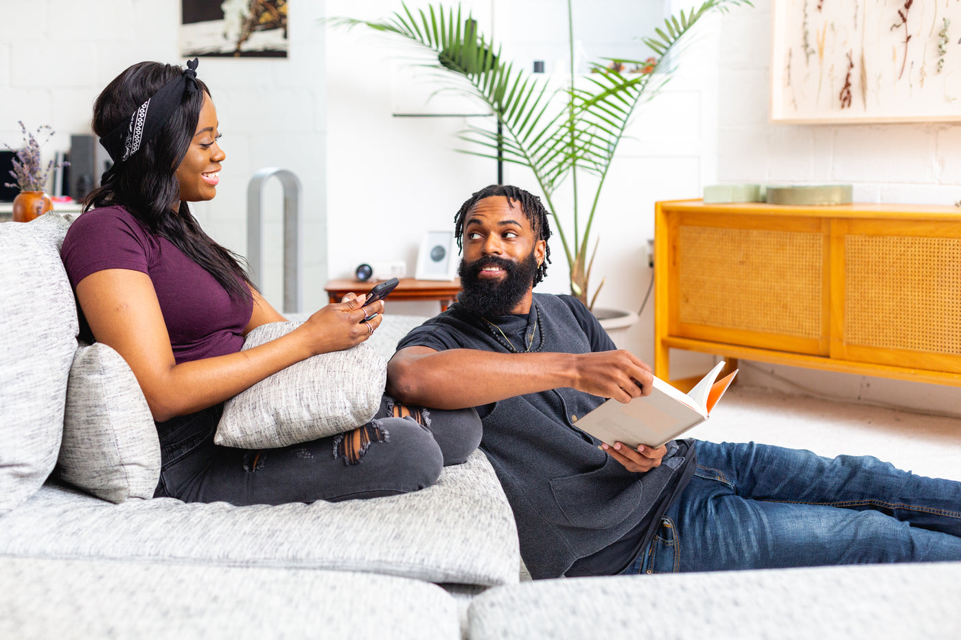 A couple relaxing in a living room with music playing